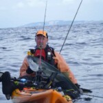 Kayak angler landing kingfish with K-Labs rod in New Zealand waters