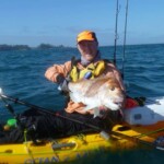 Kayak angler holding snapper caught on K-Labs custom fishing rod in New Zealand